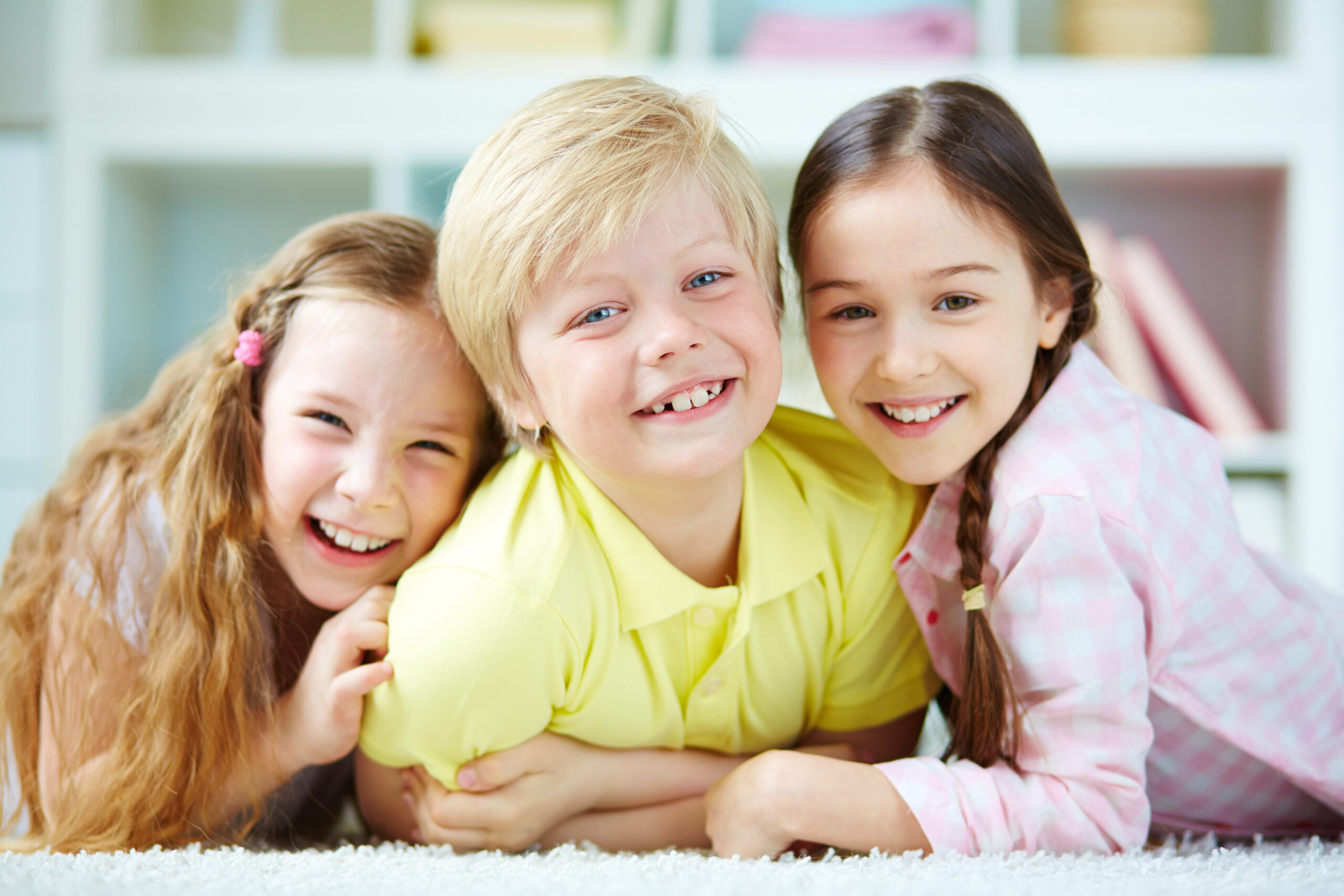Three little friends looking at camera with smiles